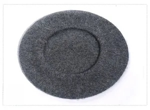 Detail of dark grey wool felt beret showing thick texture and minimalist round design