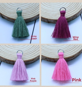 Close-up of 3.5cm cotton tassels with metal rings in army green, wine, and pink colors