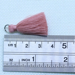 3.5cm cotton tassel pendant with metal ring in mauve purple shown with steel ruler