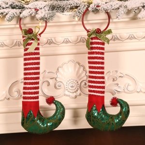 Christmas elf leg door ornaments with red stripes, green sequins, and festive bells