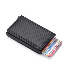 Close-up of black carbon fiber RFID blocking wallet with automatic pop-up mechanism