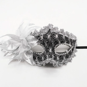 Elegant Venetian lace masquerade mask with silver flowers and feathers on white background