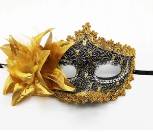 Detail of Venice lace masquerade mask with black gold lace and satin flower decoration