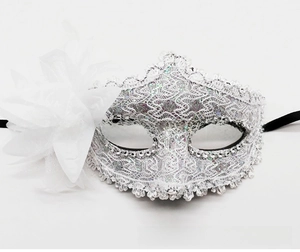 Detailed view of white lace masquerade mask with silver sequins and large silk flower