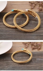Macro shot of gold spiral cable cuff bracelet featuring turquoise and marble arrow tips
