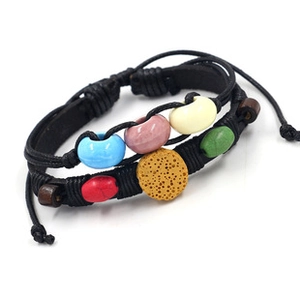 Detail of multi-layer woven leather bracelet with colorful ceramic beads and lava rock stone
