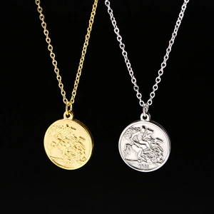 Detailed close-up of 1901 St. George coin pendants in gold and silver finishes