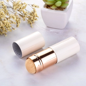 Detail of portable retractable makeup brush with rose gold connector and white cap