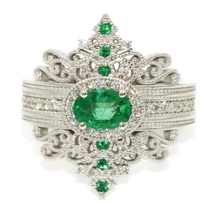 Vintage palace style copper ring featuring oval green emerald and filigree details