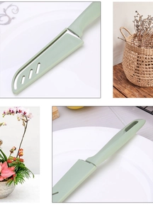Detail of a green candy-colored stainless steel paring knife with protective sheath on a plate