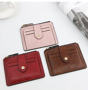 Close-up of three slim leather wallets showing litchi texture and multiple card slots