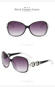 Close-up of stylish oversized sunglasses with purple gradient lenses and silver accents