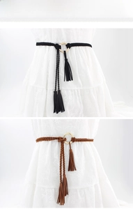 Detail of hand-woven waist belts with gold rings and tassels on floral dresses