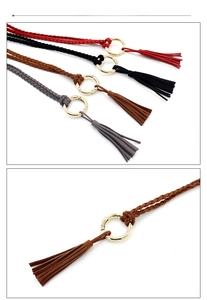 Detailed view of handmade woven waist belts with metallic rings and tassel fringe accents