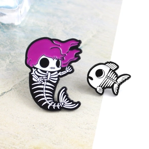 Skeleton mermaid and fish enamel pin set with purple hair on marble background