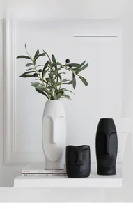 Detail of matte ceramic Nordic face vases with modern abstract art design for home decor