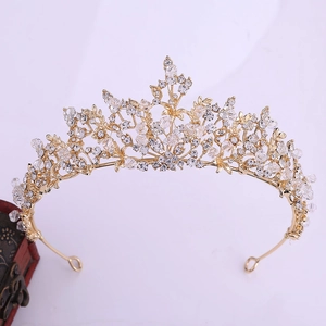 Detailed macro of crystal tiara featuring intricate floral metalwork and clear rhinestones