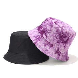 Reversible street style cotton bucket hats in solid black and purple tie-dye patterns