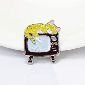 Japanese style cartoon yellow tabby cat on a vintage television enamel brooch pin