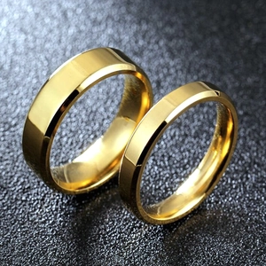 Macro shot of minimalist gold titanium steel rings with polished double beveled edges
