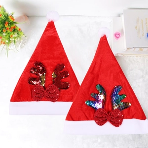 Christmas hats with red sequins and deer antlers on a white background with props