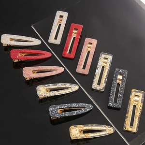 Detailed set of acetate hair clips in leopard and marble patterns with gold metal base