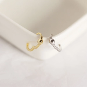 Macro view of gold and silver S925 sterling silver hoop earrings with bead detail
