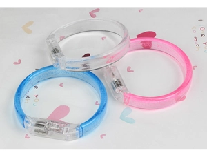 Close-up of LED glowing bracelets in blue and pink with internal electronic components