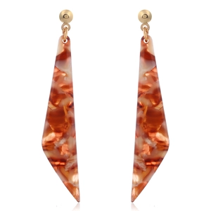 Detailed view of amber acetate drop earrings with golden studs on white background