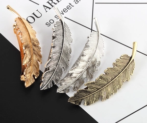 Detail view of 4-piece set leaf feather hair clips in various metallic finishes