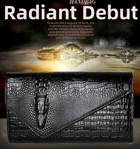 Detail of black crocodile texture clutch bag with 3D embossed crocodile head decoration