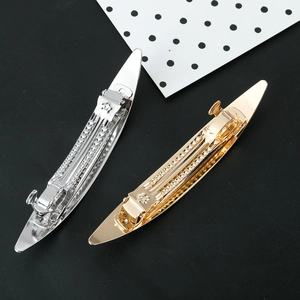Sleek metallic hair clips in gold and silver finish with minimalist curved design