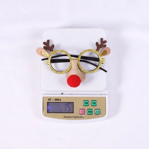 Detailed view of lightweight Christmas reindeer glasses weighing 15g on a scale