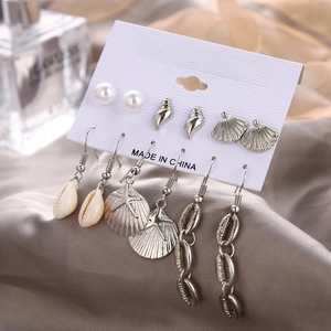 Detailed close-up of a 6-pair ocean theme earring set with starfish and seashell charms