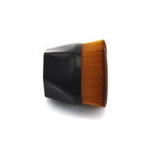 Detail shot of mini round lip brush with black faceted handle and dense brown bristles
