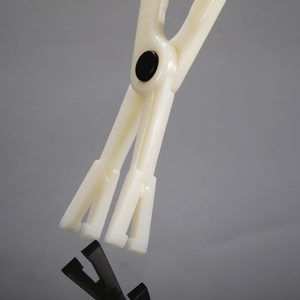 Close-up of white plastic disposable piercing clamp for sterile body art procedures