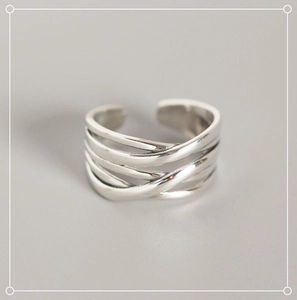 Macro shot of silver S925 sterling silver multi-layer woven line design open ring