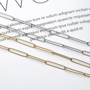 Close-up of gold and silver rectangular paperclip chain necklaces in high polished finish