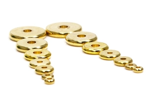 Detailed view of various sizes of solid flat brass spacers for DIY jewelry making