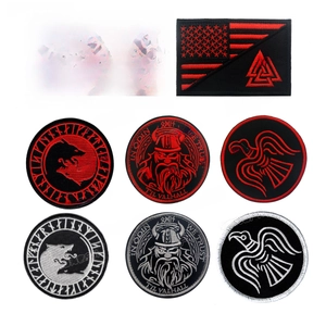 Detailed view of high-density Nordic embroidery patches including Odin and Valknut symbols