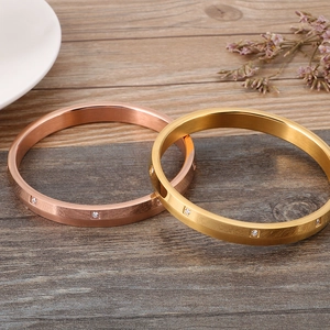 Brushed gold and rose gold stainless steel bracelets featuring square-cut zircon stones