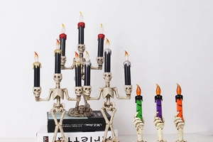 Macro view of Halloween skeleton candle holders with realistic LED flickering flames