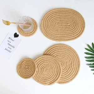 Detail view of a 4-piece handmade jute place mat set with coasters on white background
