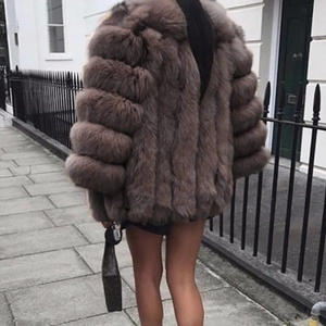 Rear view of faux fur coat in grey-brown with luxury voluminous horizontal paneling