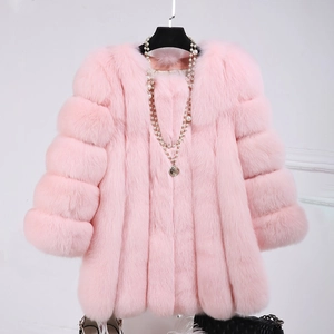 Detail of pink faux fox fur coat featuring luxury soft texture and pearl necklace accent
