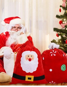 Detailed view of red velvet Christmas drawstring gift bags with Santa and candy designs