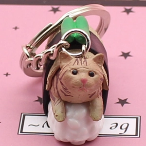 Cute orange sushi cat keychain with seaweed and fish topping on pink background
