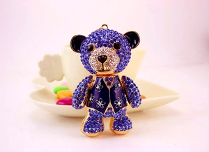 Macro view of crystal oversized bear keychain featuring deep blue rhinestones and gold alloy