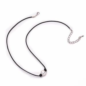 Detail of single natural freshwater pearl on black leather cord with silver lobster clasp