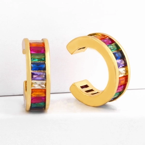 Rainbow cubic zirconia gold ear cuffs for non-pierced ears on a white platform